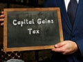 Business concept about Capital Gains Tax with sign on the black chalkboard