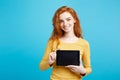 Business Concept - Close up Portrait young beautiful attractive redhair girl smiling showing digital tablet screen on Royalty Free Stock Photo