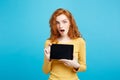 Business Concept - Close up Portrait young beautiful attractive redhair girl smiling showing digital tablet screen on Royalty Free Stock Photo