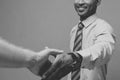 Business concept - Close-up of two confident business people shaking hands during a meeting.Black and white