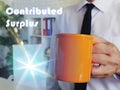 Business concept about Contributed Surplus with Man with a cup of coffee in the background Royalty Free Stock Photo