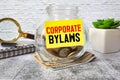 Business concept. Corporate Bylaws lettering on the money jar