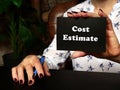 Business concept about Cost Estimate with sign on blank business card Royalty Free Stock Photo