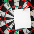 Business concept. darts arrows in the target center with paper note for Writing goals for this business year