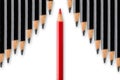 Business concept of disruption, leadership or think different; red pencil dividing row of black pencils in opposite direction