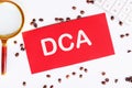 Business concept. Dollar cost averaging investment strategy. DCA on a red card