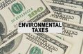 On the dollars lies a paper plate with the inscription - Environmental Taxes