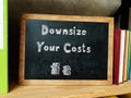 Business concept about Downsize Your Costs with inscription on the sheet