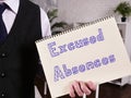 Business concept about Excused Absences with inscription on the piece of paper