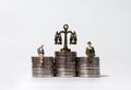 A business concept expressed in miniature and coins.