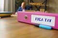 Business concept about FICA TAX Federal Insurance Contributions Act with phrase on the File Folder