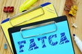 Business concept about Foreign Account Tax Compliance Act FATCA with phrase on the sheet