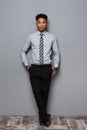 Business Concept - Full length portrait of confident african american businessman in the office.