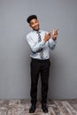 Business Concept - Full length portrait of confident african american businessman in the office pointing finger on side Royalty Free Stock Photo