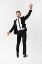 Business Concept: Full-length Portrait excited handsome business man with arms raised in success. Isolated on grey Royalty Free Stock Photo