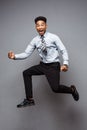 Business Concept - Full length portrait of successful african american businessman happy jumping in the office. Royalty Free Stock Photo