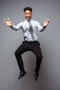 Business Concept - Full length portrait of successful african american businessman happy jumping in the office. Royalty Free Stock Photo