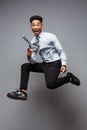 Business Concept - Full length portrait of successful african american businessman happy jumping in the office. Royalty Free Stock Photo