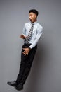 Business Concept - Full length portrait of successful african american businessman surprising jump in the office. Royalty Free Stock Photo