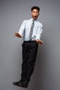 Business Concept - Full length portrait of successful african american businessman surprising jump in the office. Royalty Free Stock Photo