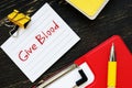 Business concept about Give Blood with sign on the page