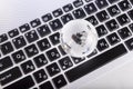 Business concept of glass globe on a laptop keyboard Royalty Free Stock Photo