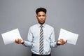 Business Concept - handsome young professional african american businessman holding report papers. Royalty Free Stock Photo