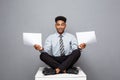 Business Concept - handsome young professional african american businessman holding report papers. Royalty Free Stock Photo