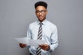 Business Concept - handsome young professional african american businessman holding report papers. Royalty Free Stock Photo
