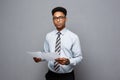 Business Concept - handsome young professional african american businessman holding report papers. Royalty Free Stock Photo