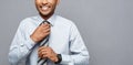 Business Concept - Happy confident professional african american businessman posing over grey background.