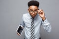 Business Concept - Happy handsome professional african american businessman holding tablet with surprising facial Royalty Free Stock Photo