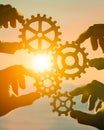 Business concept idea. four hands of businessmen collect a puzzle from gears.