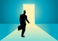 Businessman walking towards a bright door