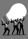 Businessmen lifting up a light bulb together