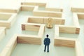 Business concept image of and challenge. A man stands in the maze looking for the exit. Problem solving and decision making idea Royalty Free Stock Photo