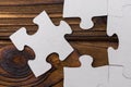 Business concept image for completing the final puzzle piece. wooden background.