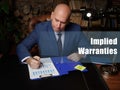 Business concept about Implied Warranties . Closeup portrait of unrecognizable successful businessman wearing formal suit reading