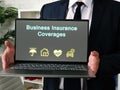 Business concept about Business Insurance Coverages with inscription on the piece of paper