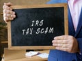 Business concept about IRS TAX SCAM with sign on the blackboard Royalty Free Stock Photo
