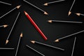 Business concept of leadership, standing out from the crowd or think different; red pencil in group of black pencils Royalty Free Stock Photo