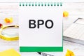 Business concept. Letters BPO. Business Process Outsourcing on a blank sheet in a notebook Royalty Free Stock Photo