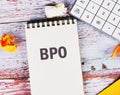 Business concept. Letters BPO. Business Process Outsourcing in a white notebook on old boards Royalty Free Stock Photo