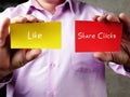 Business concept about Like Share Clicks  with sign on the piece of paper Royalty Free Stock Photo