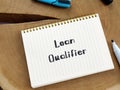 Business concept about Loan Qualifier with inscription on the sheet Royalty Free Stock Photo