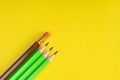 Business concept - lot of same pencils and one different pencil on yellow paper background. It`s symbol of leadership, teamwork. Royalty Free Stock Photo