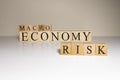 Business concept. Macro, economy, risk words are written with wooden cubes Royalty Free Stock Photo