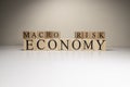 Business concept. Macro, economy, risk words are written with wooden cubes Royalty Free Stock Photo
