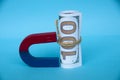 Business concept. Magnet attract money on blue cover background. Copy space