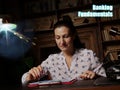 Business concept meaning Banking Fundamentals Female office workers with yellow shirt holding and writing documents on office desk